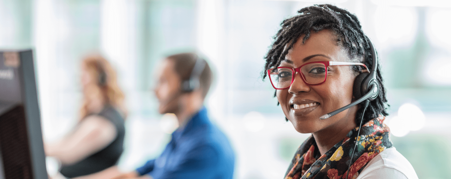 Customer service representative smiling wearing headset