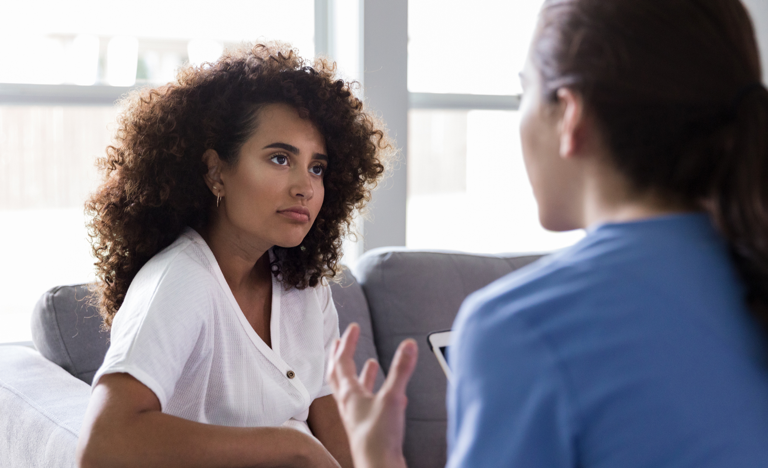 Healthcare provider having a serious conversation with female patient