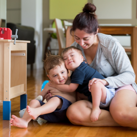 A boy with Down syndrome hugs his little brother