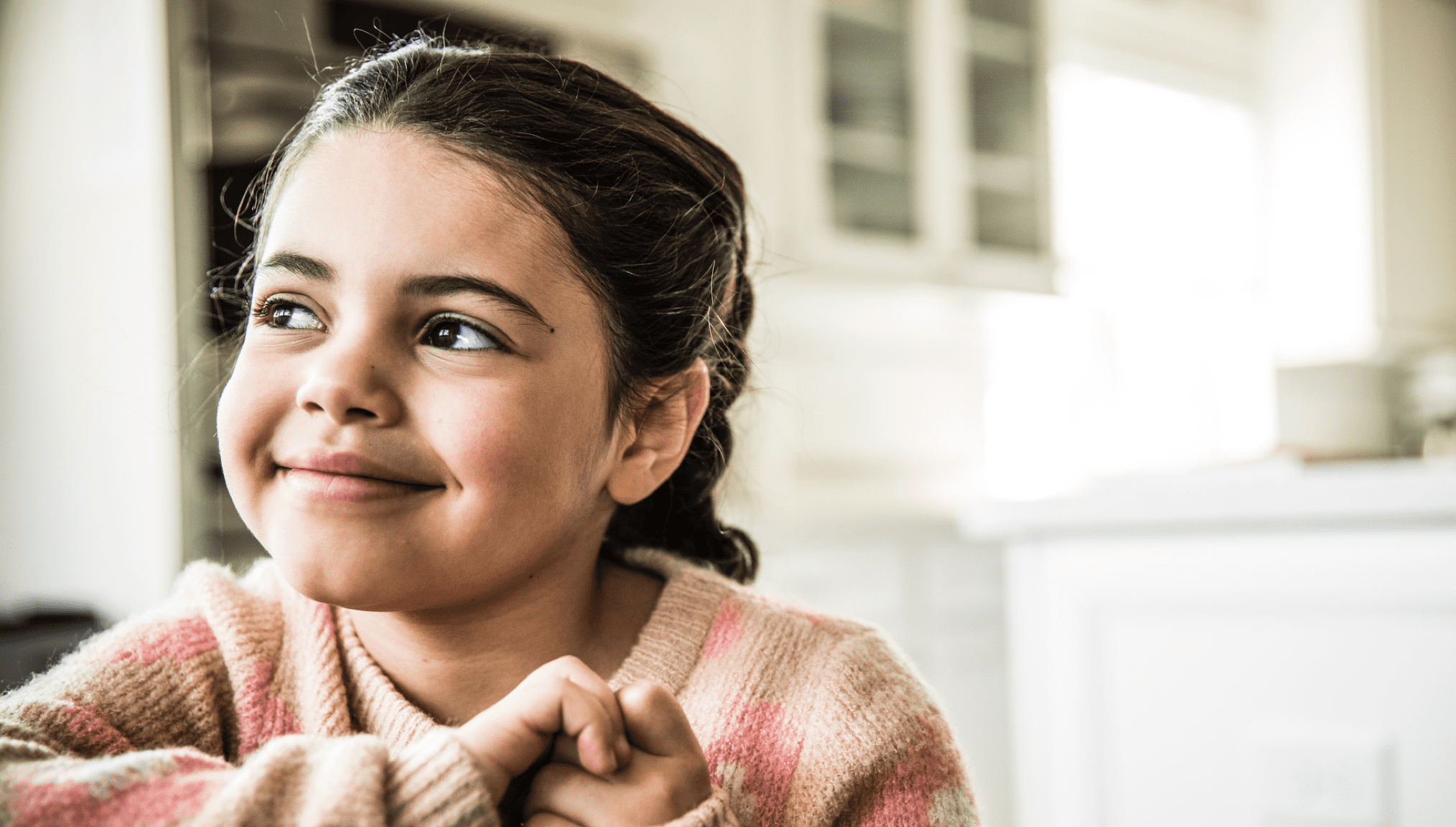 Young girl smiling in kitchen