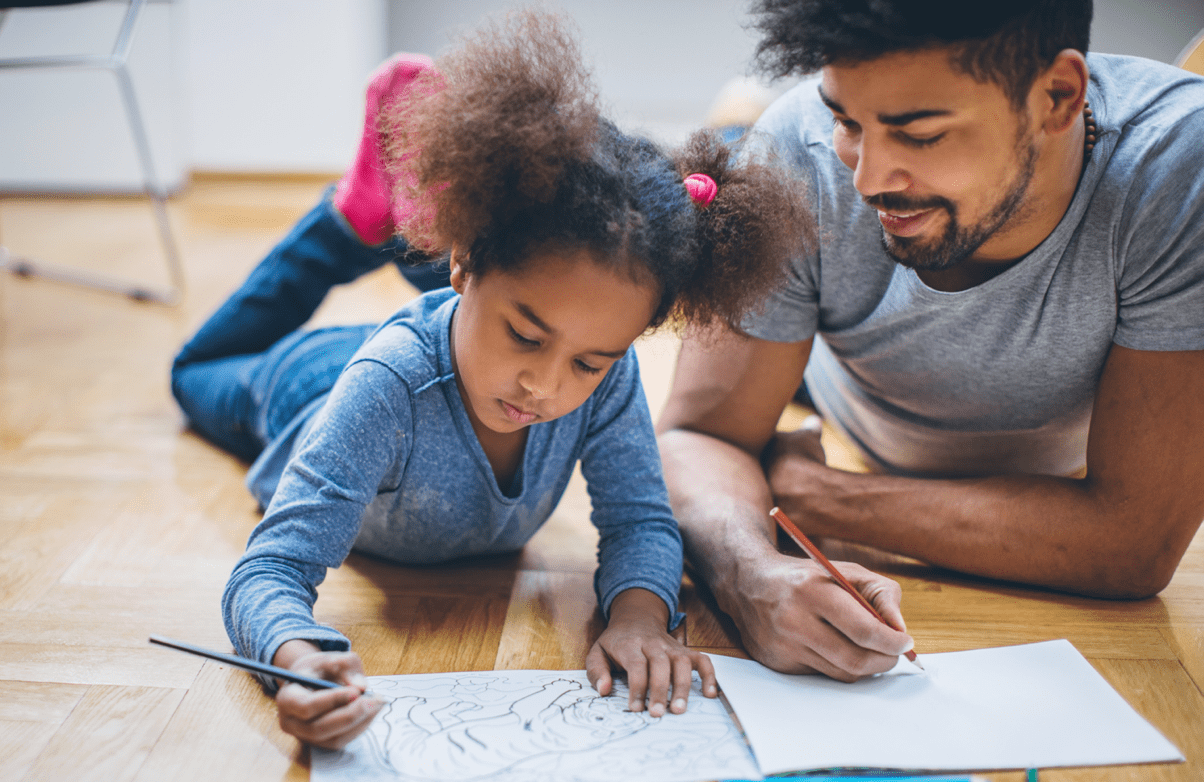 Father and daughter coloring together