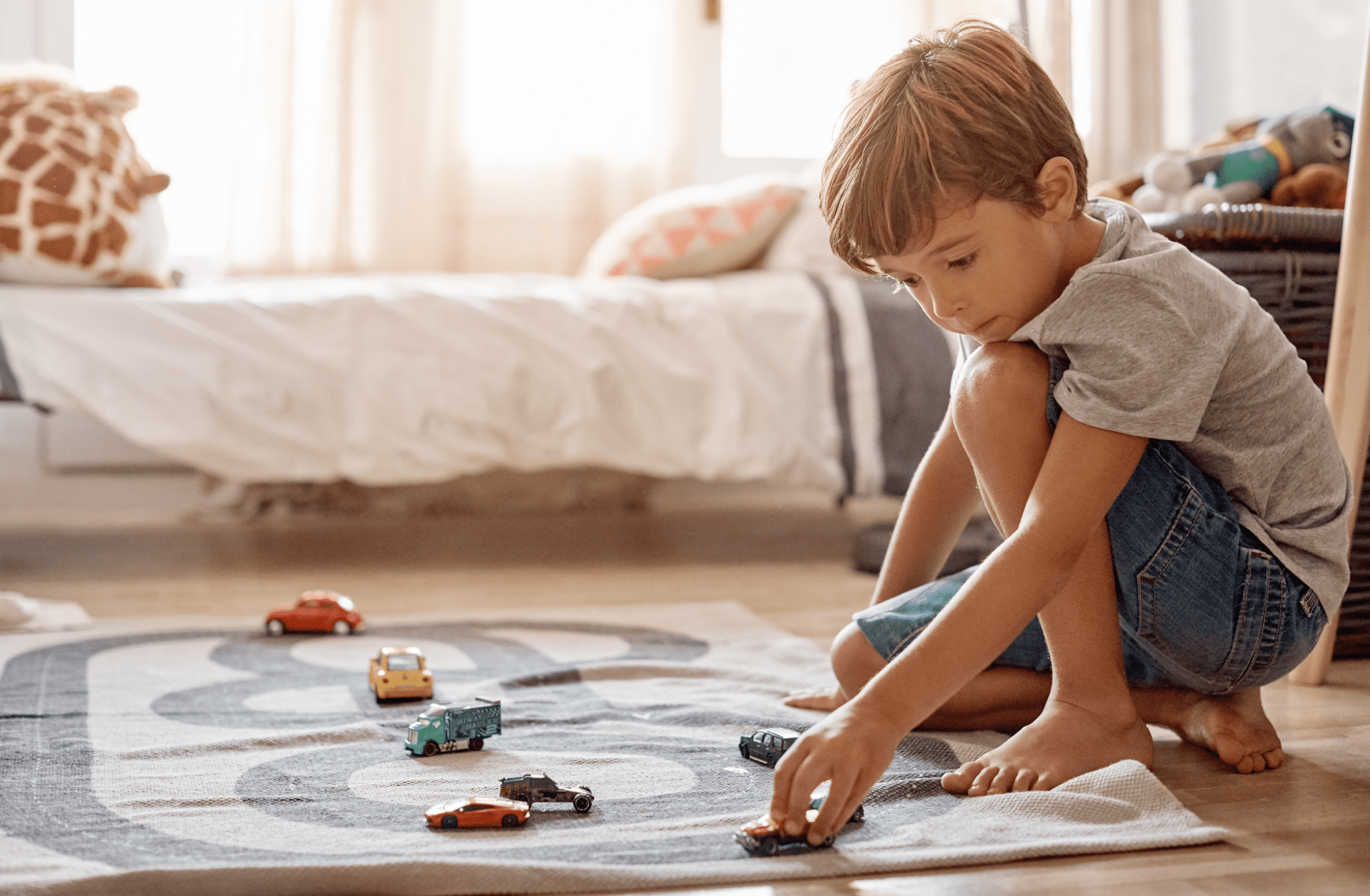 Little boy playing with his toys at home