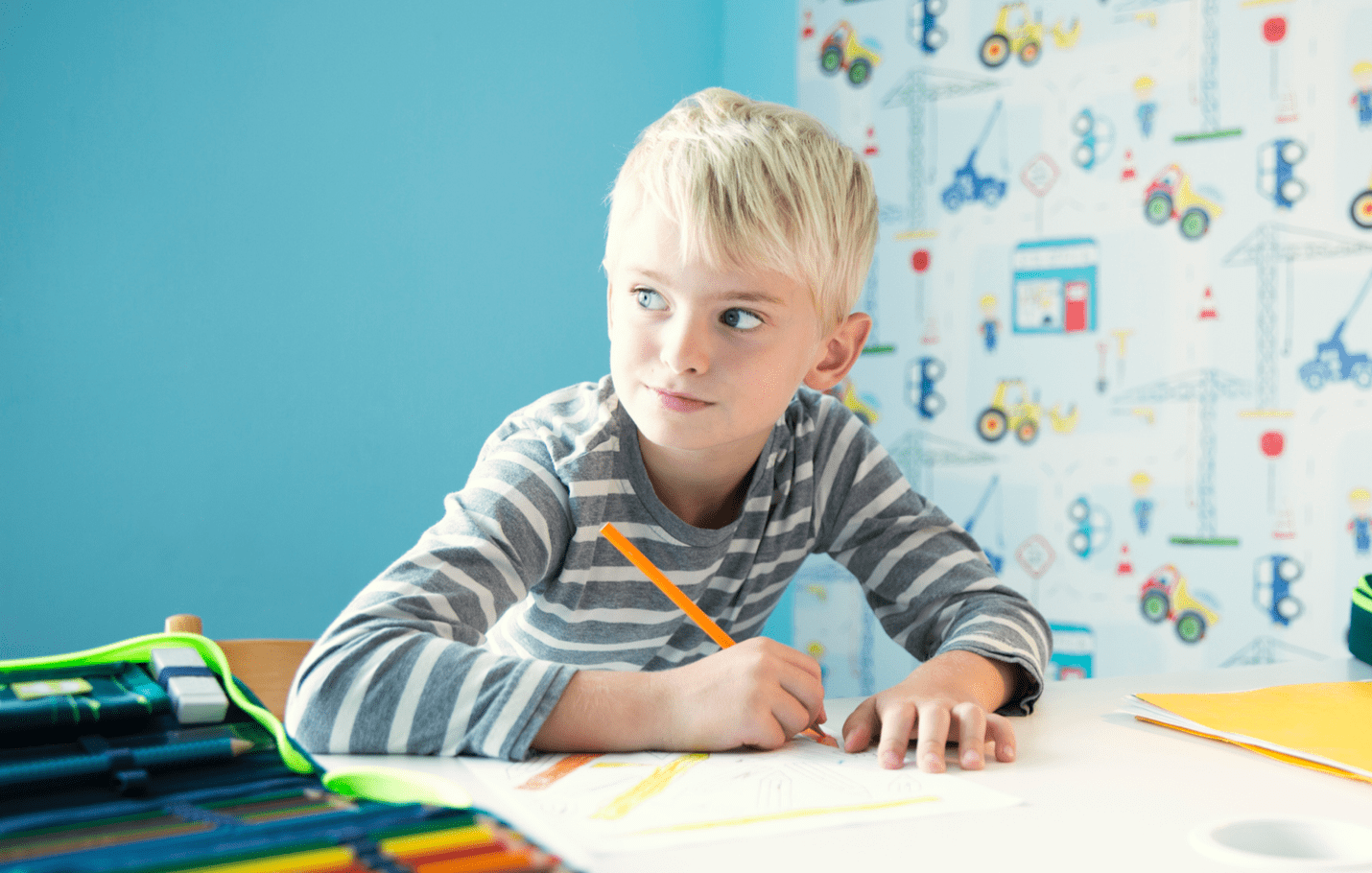 Boy doing homework at desk in children's room