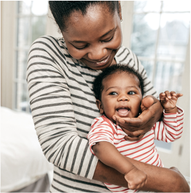 Mom holding newborn baby at home