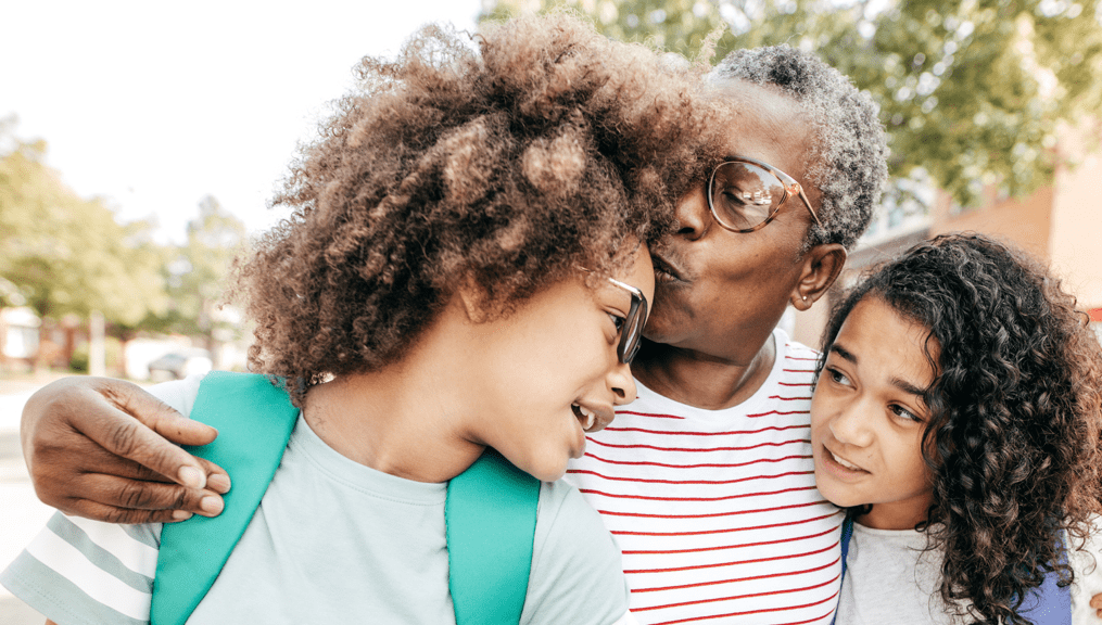A woman relaxing on her couch while she looks at a iPad.