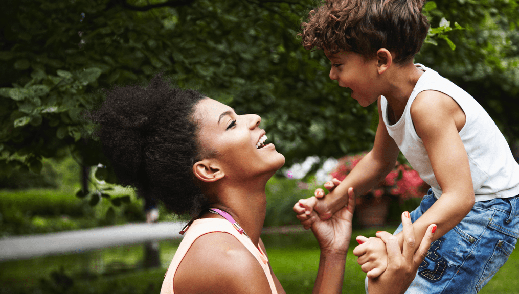 Mother with young son playing in park